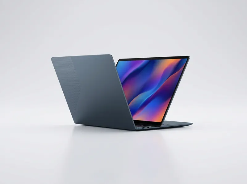 Slim blue-grey ultrabook with geometric lid detail, open at an angle