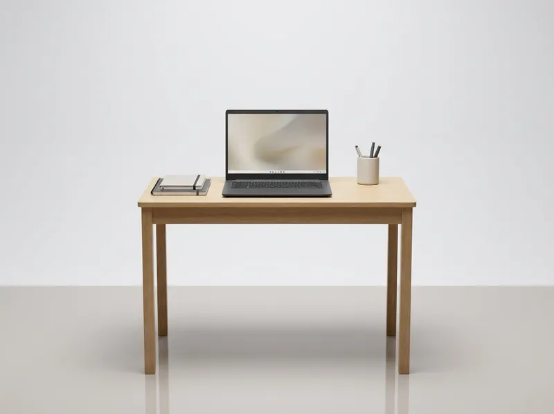 Simple grey budget laptop open on a student desk, clean lighting